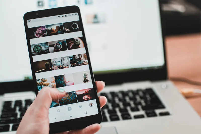 Smartphone showing a social media feed, representing a retargeting ad reaching a shopper after they left the store