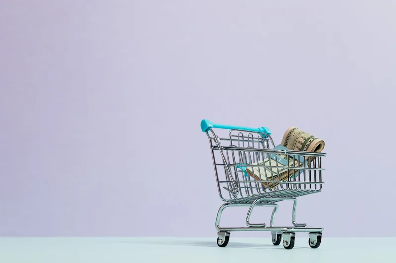 Financial planning documents and calculator showing marketing budget allocation for ecommerce sellers