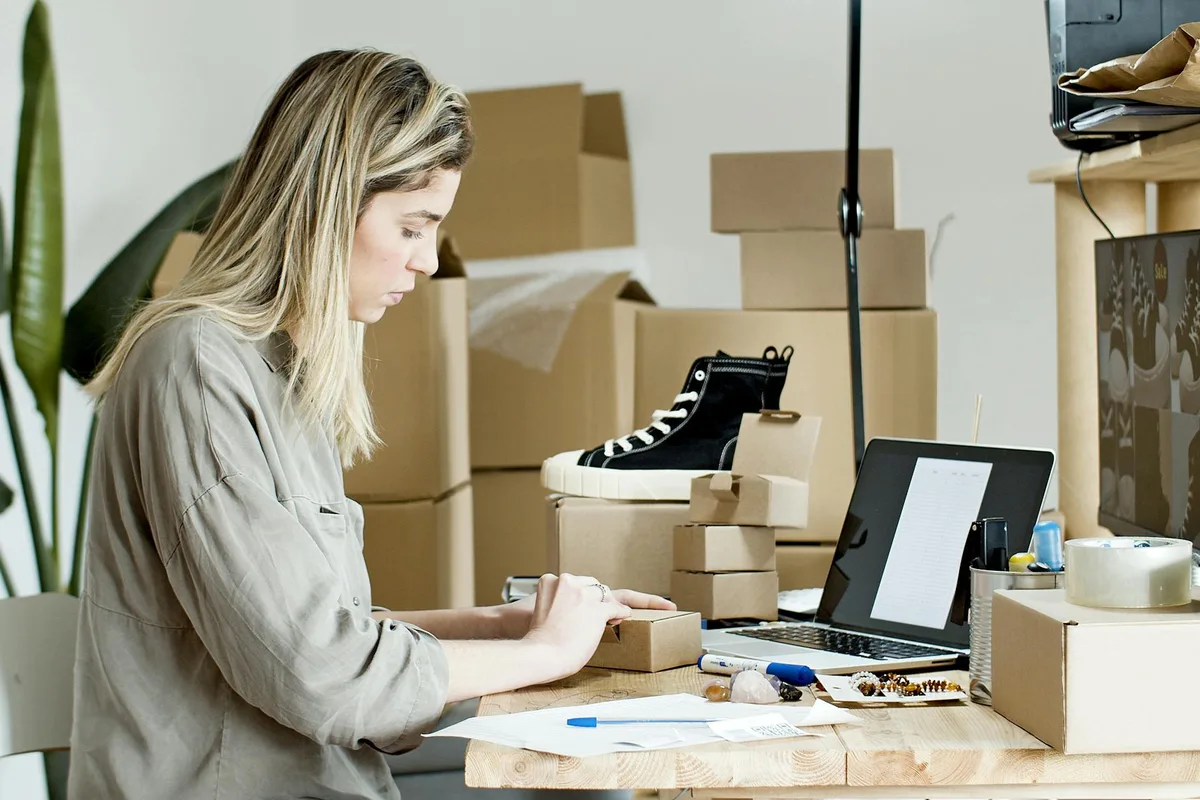 Woman managing ecommerce products and preparing items for shipping
