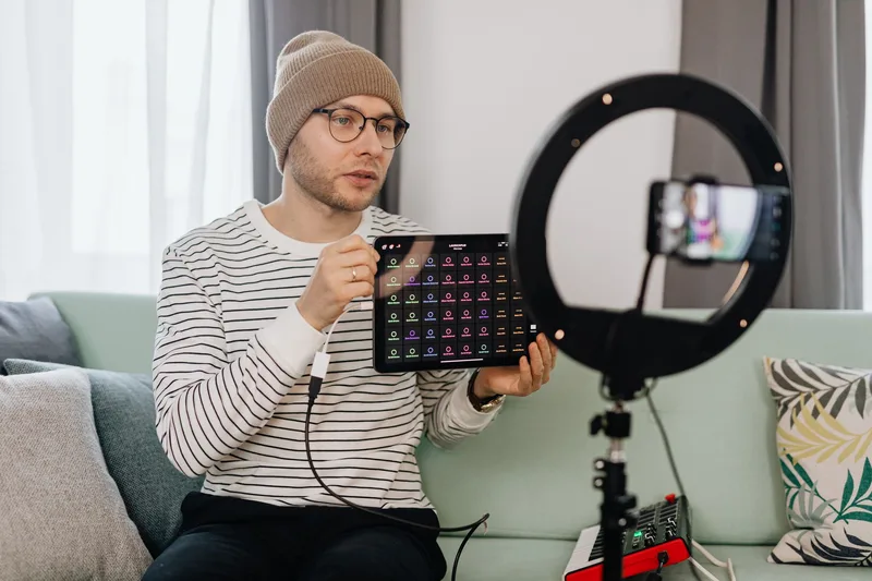 Content creator filming a product review video for TikTok using a ring light and smartphone setup